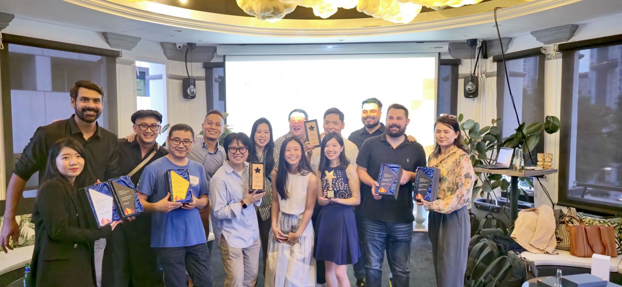 HubSpot Asia partner award winners from FY2024, including Aaron Goh, holding their trophies together