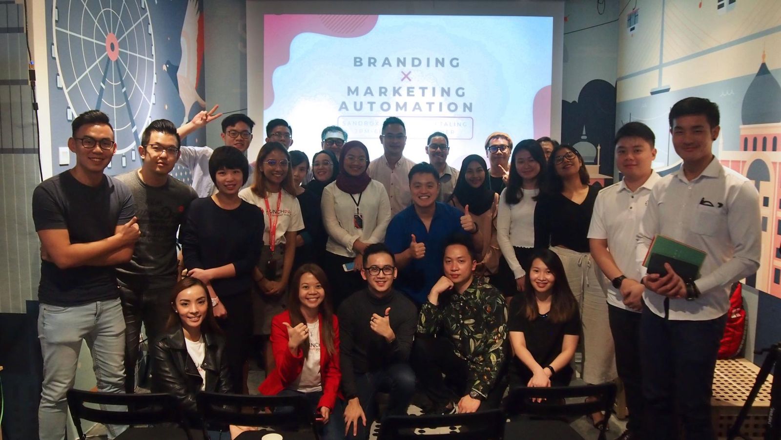 Participants of a branding and marketing automation workshop giving a thumbs up