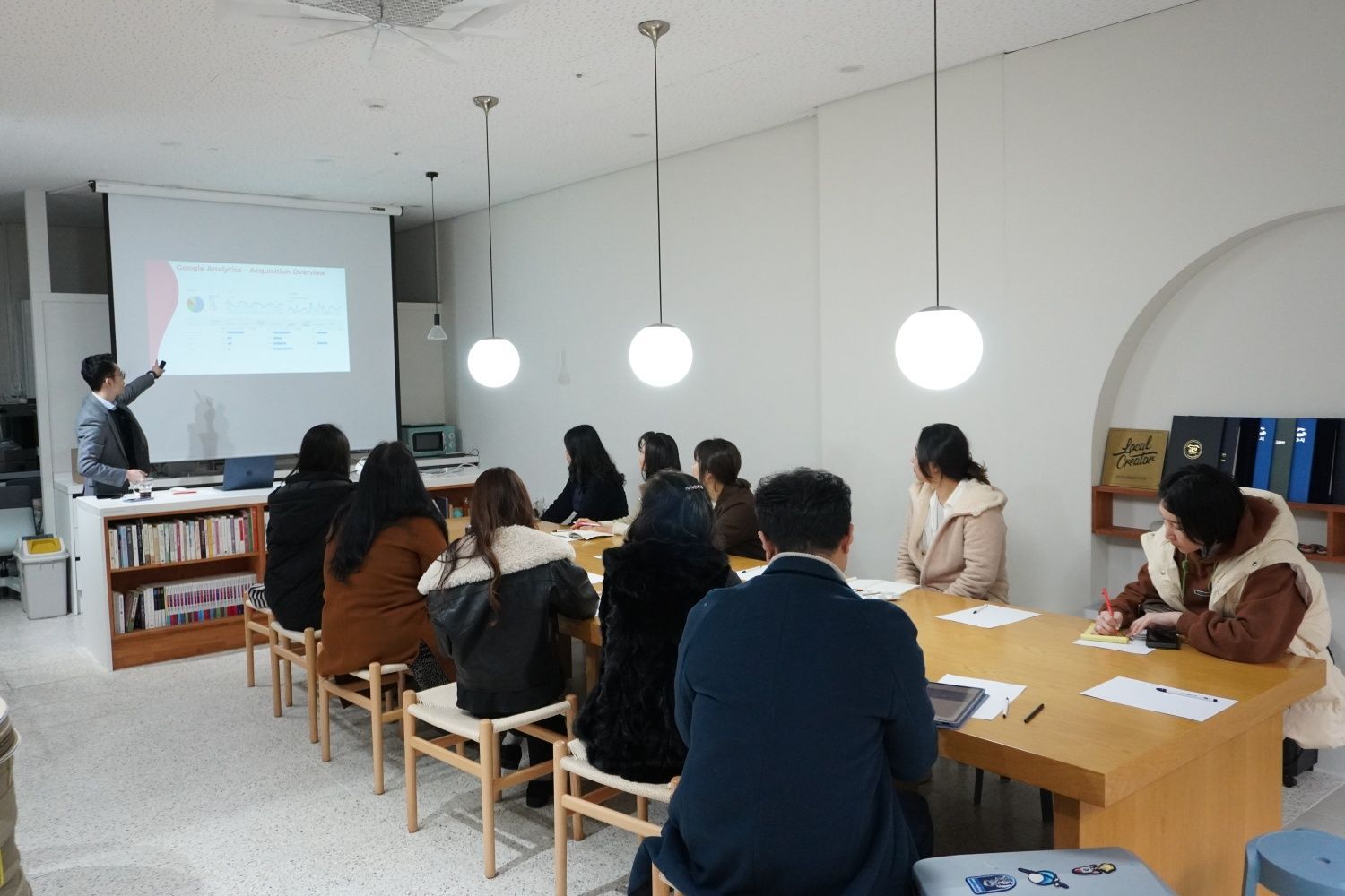 An Azend trainer presenting an analytics session to a classroom of participants
